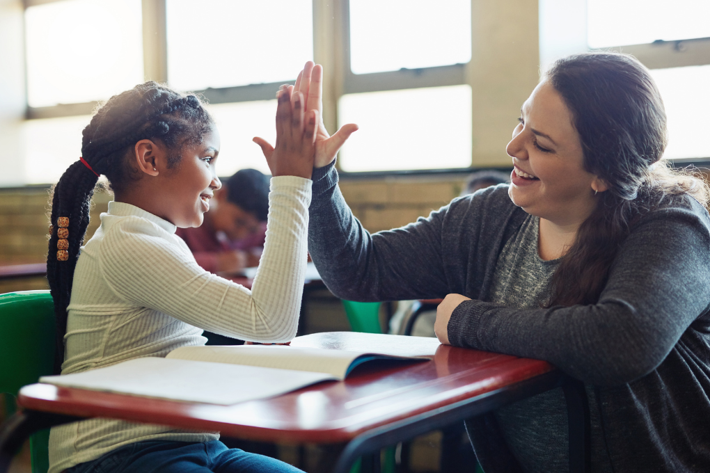 Teacher and Learner High-Five During Activity